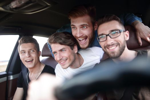 Happy people of different ethnic groups in the car