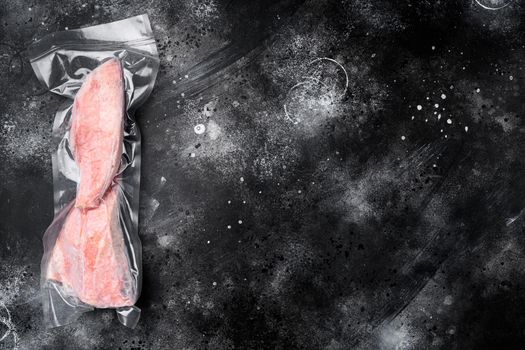 Red perch frozen pack fish meat set, on black dark stone table background, top view flat lay, with copy space for text