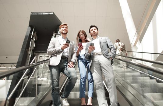 employees of the company standing on the escalator. people and technology