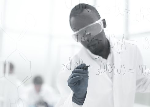 scientist writing chemical formula on a glass Board.photo with copy space