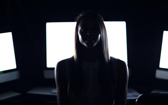 close up.a young woman near the desktop.the concept of e-business