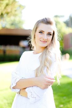 Portrait of young blonde woman wearing white clothes. Concept of beauty and female person.