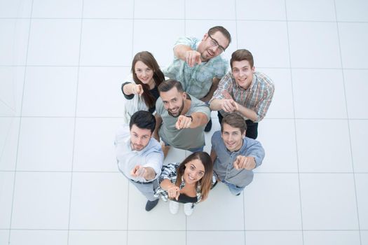top view.a group of successful young people pointing to you.photo with copy space