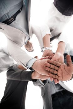 close up.business team folded their hands together.business background