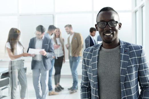 young businessman standing in the hall of the modern office .business concept