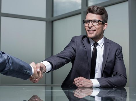 close up.business man shaking hands with his business partner .photo with copy space