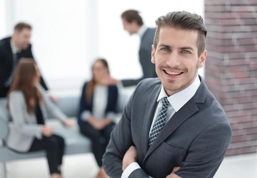 close-up of a successful businessman, against colleagues