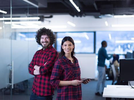 portrait of successful business couple software developers at busy startup office