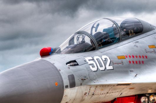 air fighter on the ground, details of the cockpit,  blue sky in background