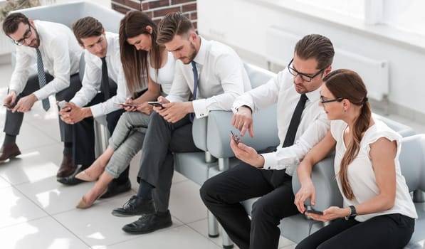 business team sitting in the lobby of the business center .business concept