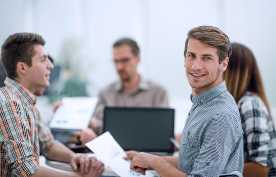 close up.successful employee sitting at the Desk.photo with copy space