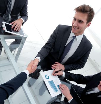 handshake business colleagues in office