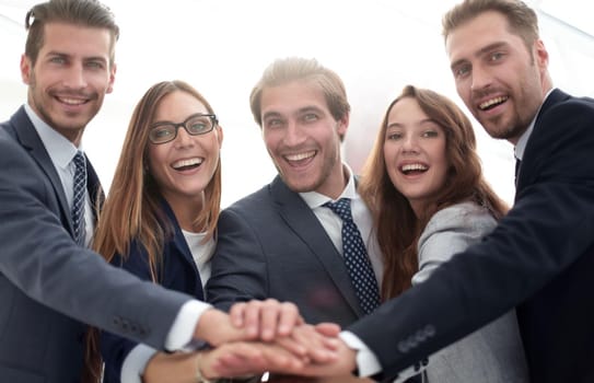 Creative team putting their hands together in circle