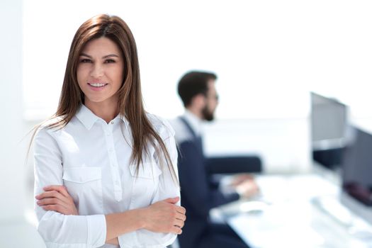 smiling business woman on the background of the workplace. photo with copy space