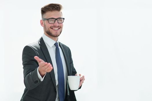 friendly businessman with a Cup of tea invites you.photo with copy space