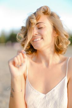 Close up portrait of young blonde smiling woman without makeup. Concept of natural beauty and feamale person.