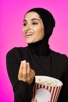 arab woman attractive look popcorn glasses movie watching studio lifestyle. High quality photo