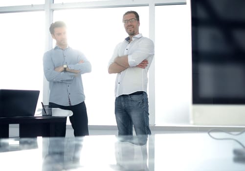 business background.two employees standing in a modern office. business concept