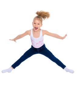 A little girl gymnast joyfully jumps and wags her hands. The concept of sport and fitness. Isolated over white background