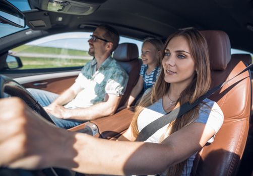 mom driving a family car .the concept of freedom and travel