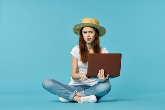 woman with laptop learning internet online education blue background. High quality photo