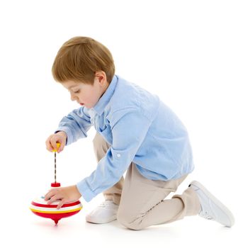 Little boy playing with a whirligig. Isolated on white background.