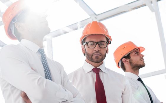 close up.background image of a group of business people in protective helmets