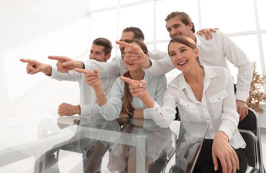 young business team confidently pointing forward.the concept of choice
