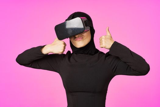 muslim woman wearing virtual reality glasses entertainment technology device. High quality photo