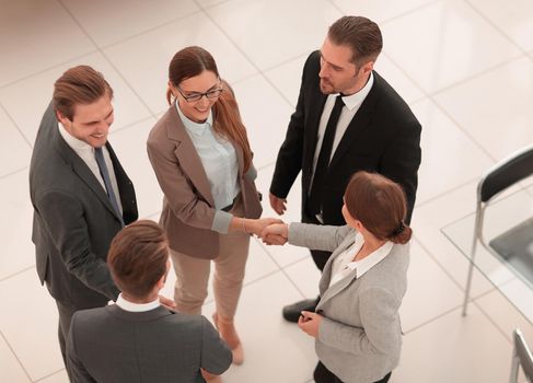 top view.handshake trading partners in the office.concept of partnership
