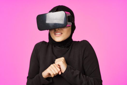 woman in black hijab glasses virtual reality technology movie watching. High quality photo