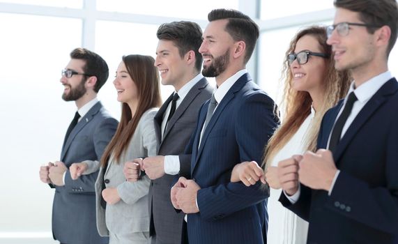 close up. business team holding each other's hands.the concept of teamwork.