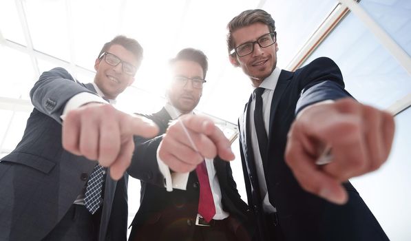 We choose you! three business men pointing at you.the concept of choice
