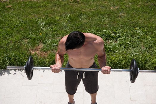 young handsome man doing morning exercises in front of his luxury home villa