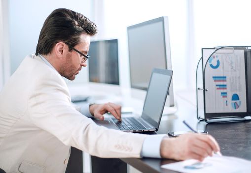 Executive businessman writing down information in a notebook.business concept