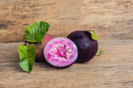 fresh Chrysophyllum cainito fruits on wood background.