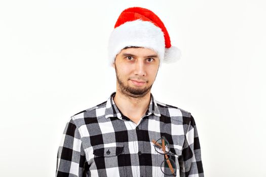 Holidays and presents concept - Funny man in Christmas hat on white background with copyspace.