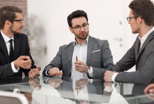business colleagues are discussing something sitting at the office table.business concept