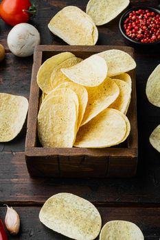 Delicious crispy potato chips set, on old dark wooden table