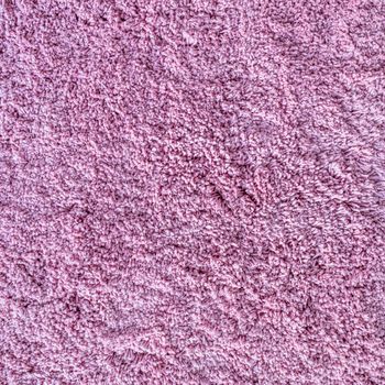 Long pile carpet texture. Abstract background of shaggy pink fibers.