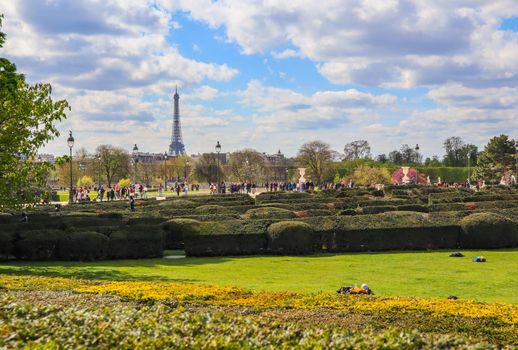 Paris / France - April 04 2019: In wonderful Tuileries garden of Louvre in spring. View on Eiffel tower
