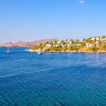 Aegean coast with marvelous blue water, rich nature, islands, mountains and small white houses