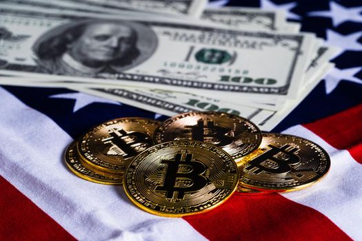 Crypto currency concept. Gold Bitcoin coins and banknote on flag of United States of America USA