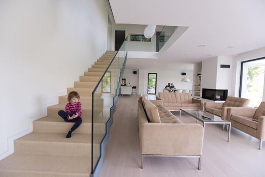 happy young family with little girl enjoys in the modern living room of their luxury home villa