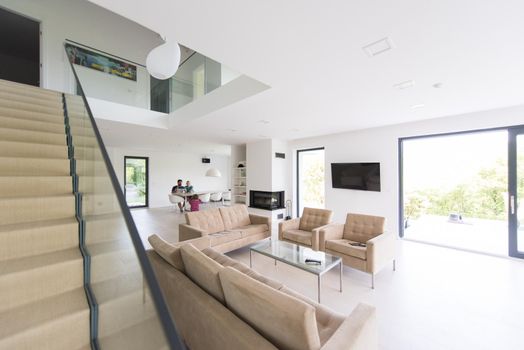 happy young family with little girl enjoys in the modern living room of their luxury home villa