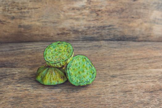 Lotus seeds on an old wooden background.