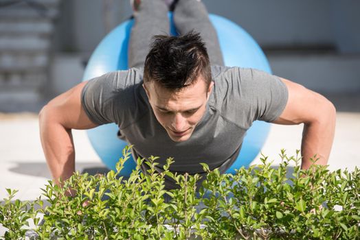 young handsome man doing morning yoga exercises in front of his luxury home villa