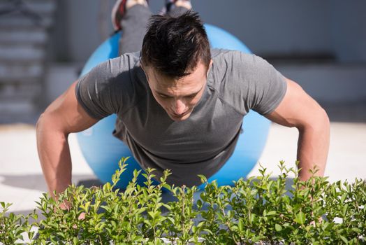 young handsome man doing morning yoga exercises in front of his luxury home villa