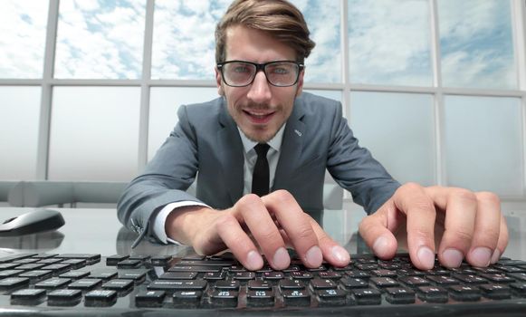 Portrait of a young man.Peets on the keyboard. Look at the camera