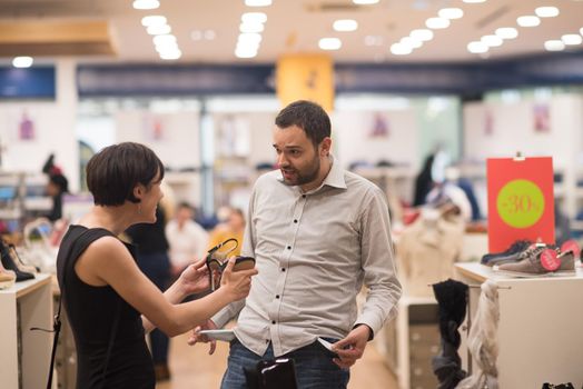 A young attractive couple changes the look with new shoes  At Shoe Store